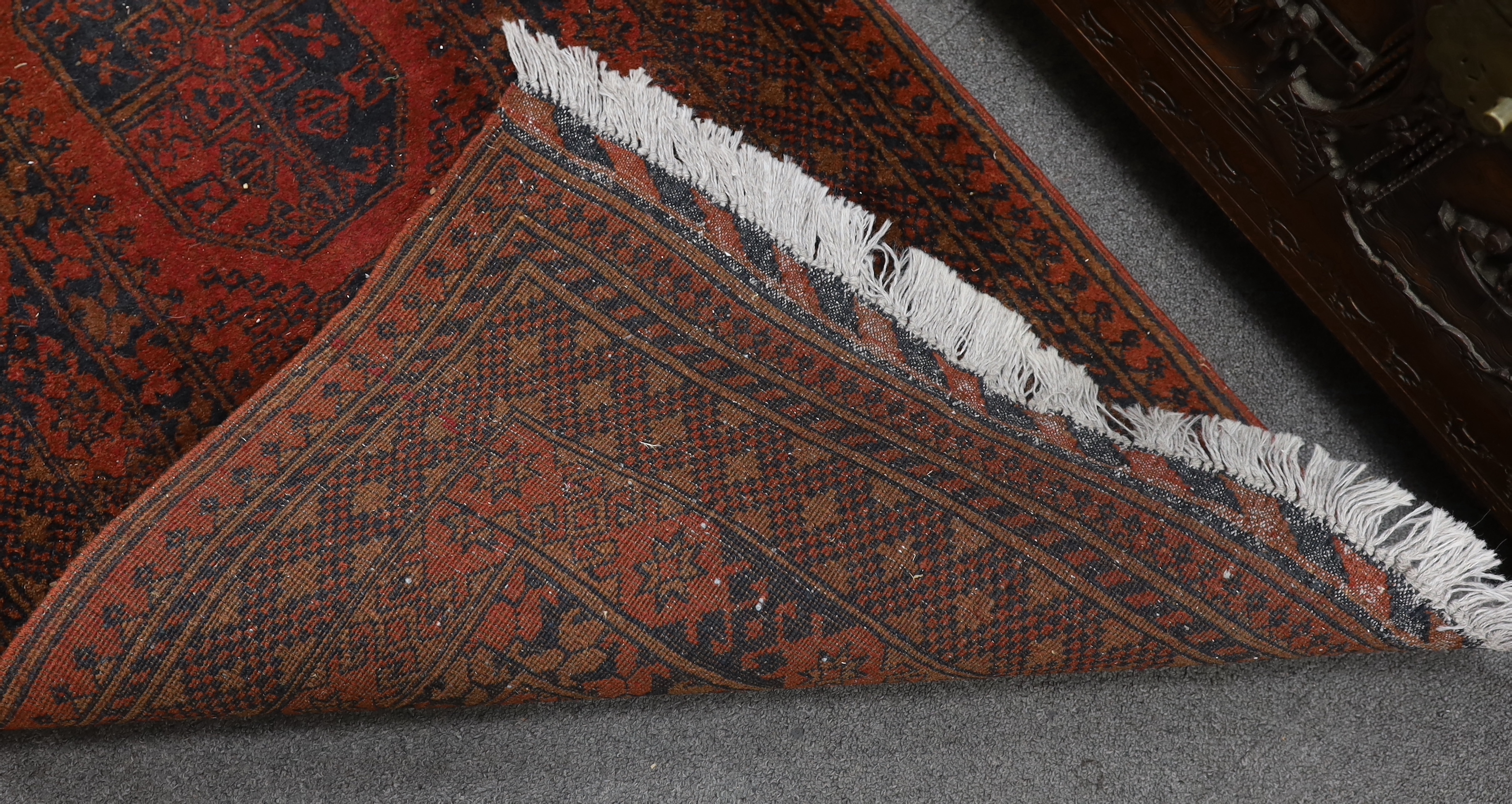 An Afghan red ground runner, 290 x 79cm